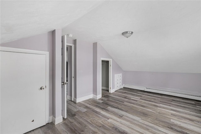 100 Pine Grove St, East Providence, RI 02916 - additional living space featuring vaulted ceiling, wood finished floors, and a baseboard heating unit
