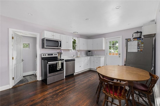 100 Pine Grove St, East Providence, RI 02916 - kitchen with appliances with stainless steel finishes, light countertops, white cabinets, dark wood-style flooring, and recessed lighting