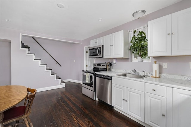 100 Pine Grove St, East Providence, RI 02916 - kitchen featuring stainless steel appliances, dark wood-style flooring, light countertops, and white cabinetry
