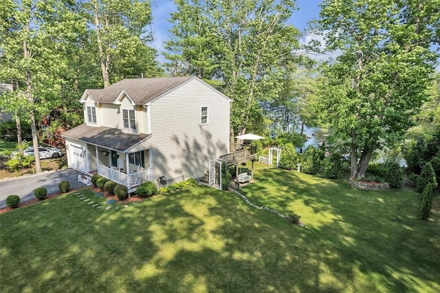 21 Laurel Dr, Glocester, RI 02814 - view of property exterior with an attached garage, driveway, a yard, view of wooded area, and roof with shingles