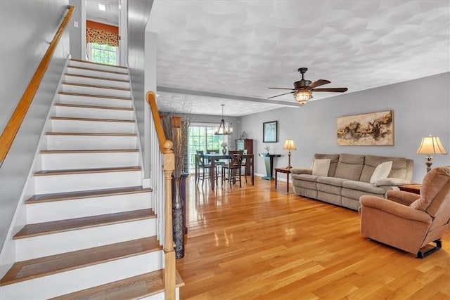 21 Laurel Dr, Glocester, RI 02814 - living area featuring ceiling fan, light wood-style floors, stairway, and a chandelier