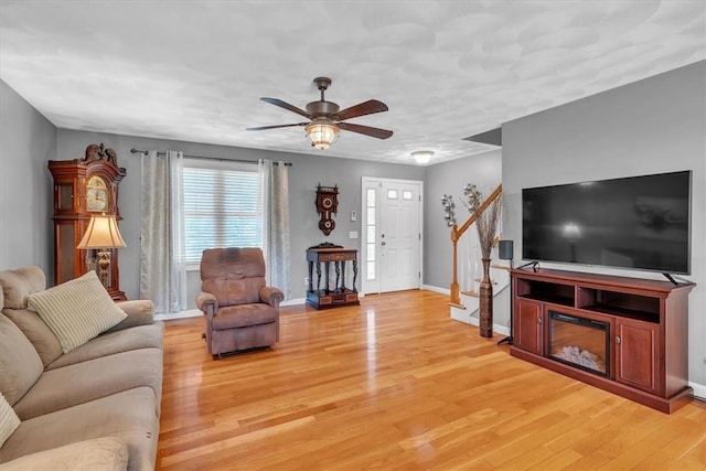 21 Laurel Dr, Glocester, RI 02814 - living room featuring light wood-style flooring, ceiling fan, and stairs