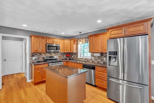 21 Laurel Dr, Glocester, RI 02814 - kitchen with appliances with stainless steel finishes, a kitchen island, light wood-style flooring, tasteful backsplash, and recessed lighting