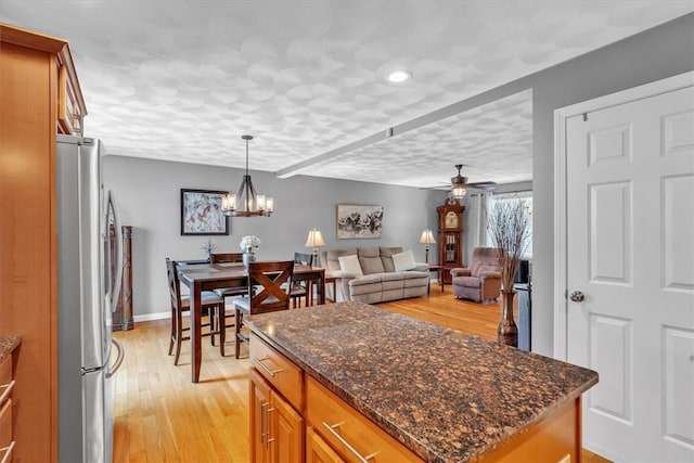 21 Laurel Dr, Glocester, RI 02814 - kitchen with freestanding refrigerator, brown cabinetry, light wood finished floors, decorative light fixtures, and a ceiling fan