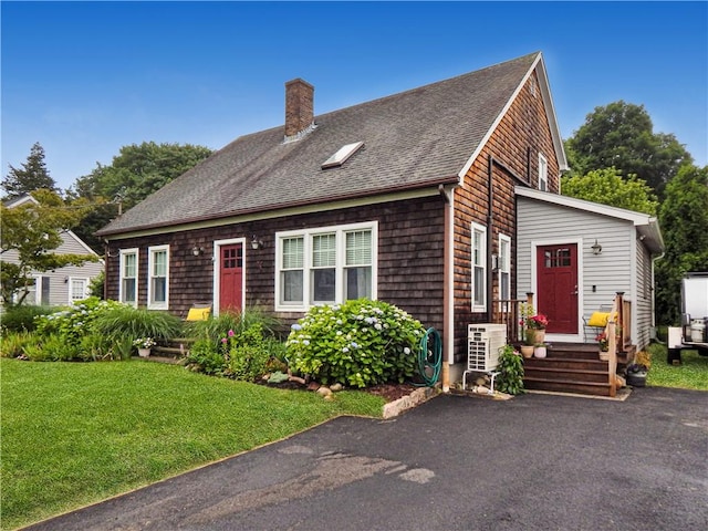 10 N Dr, Westerly, RI 02891 - view of front of home with a chimney, roof with shingles, and a front lawn
