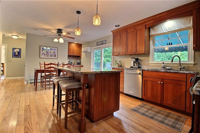 10 N Dr, Westerly, RI 02891 - kitchen with stainless steel dishwasher, a wall mounted air conditioner, a kitchen island, ceiling fan, and light wood-style floors