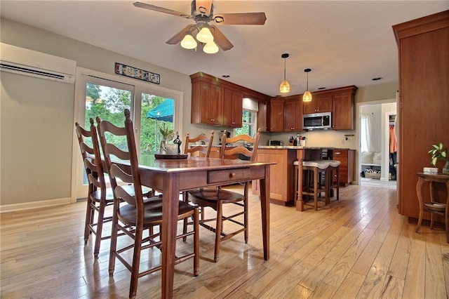 10 N Dr, Westerly, RI 02891 - dining area with a wall mounted AC, healthy amount of natural light, light wood-style flooring, and ceiling fan
