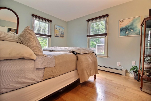 10 N Dr, Westerly, RI 02891 - bedroom featuring a baseboard heating unit, light wood-type flooring, and multiple windows