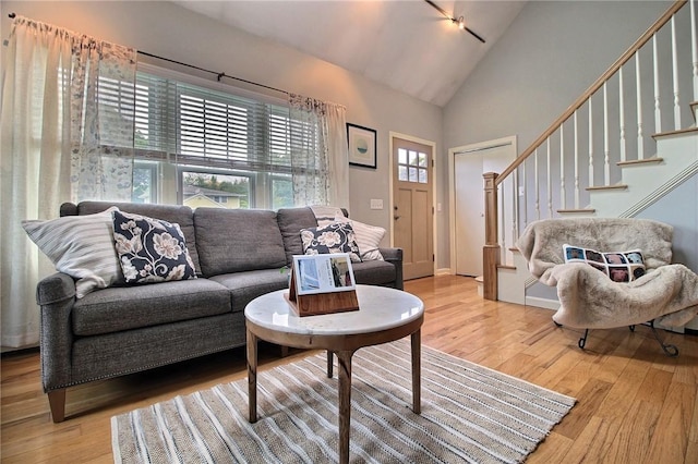 10 N Dr, Westerly, RI 02891 - living room featuring light wood-style flooring, high vaulted ceiling, and stairs