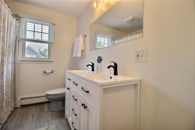 10 N Dr, Westerly, RI 02891 - bathroom with baseboard heating, double vanity, and wood finished floors