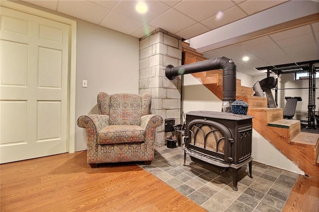 10 N Dr, Westerly, RI 02891 - sitting room featuring a paneled ceiling, wood finished floors, a wood stove, and stairs