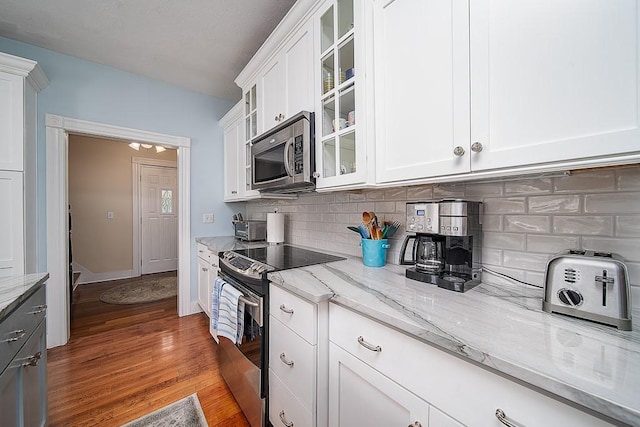 40 Vine St, East Greenwich, RI 02818 - kitchen with stainless steel appliances, light stone counters, tasteful backsplash, and white cabinets