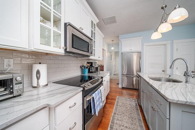 40 Vine St, East Greenwich, RI 02818 - kitchen with stainless steel appliances, dark wood-type flooring, backsplash, and pendant lighting