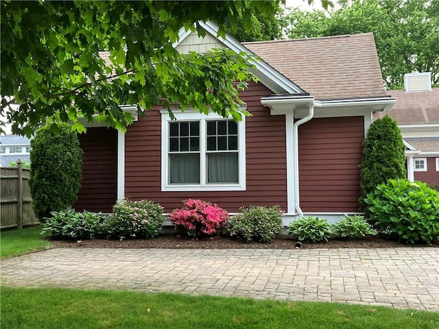 40 Vine St, East Greenwich, RI 02818 - view of side of home featuring roof with shingles
