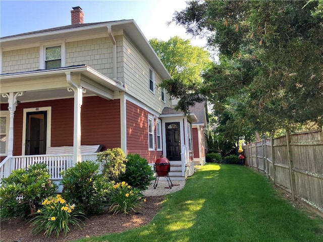 40 Vine St, East Greenwich, RI 02818 - view of home's exterior featuring a chimney and a porch