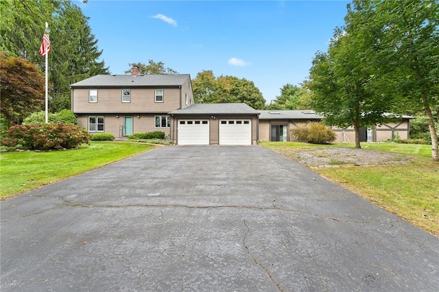 1451 Ministerial Rd, South Kingstown, RI 02879 - colonial house with asphalt driveway, a garage, a chimney, and a front lawn