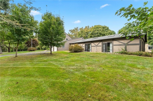 1451 Ministerial Rd, South Kingstown, RI 02879 - rear view of property featuring stucco siding and a lawn