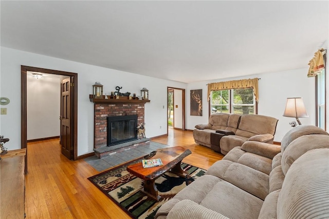 1451 Ministerial Rd, South Kingstown, RI 02879 - living area featuring light wood-type flooring and a fireplace