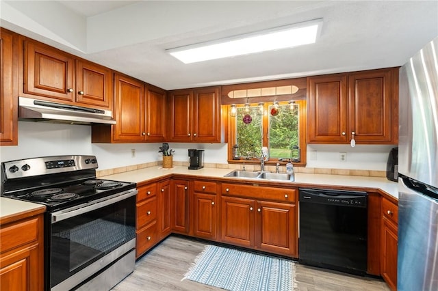 1451 Ministerial Rd, South Kingstown, RI 02879 - kitchen with appliances with stainless steel finishes, under cabinet range hood, light wood-style floors, and light countertops