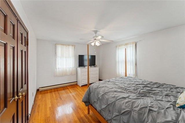 1451 Ministerial Rd, South Kingstown, RI 02879 - bedroom featuring baseboard heating, multiple windows, light wood-type flooring, and ceiling fan