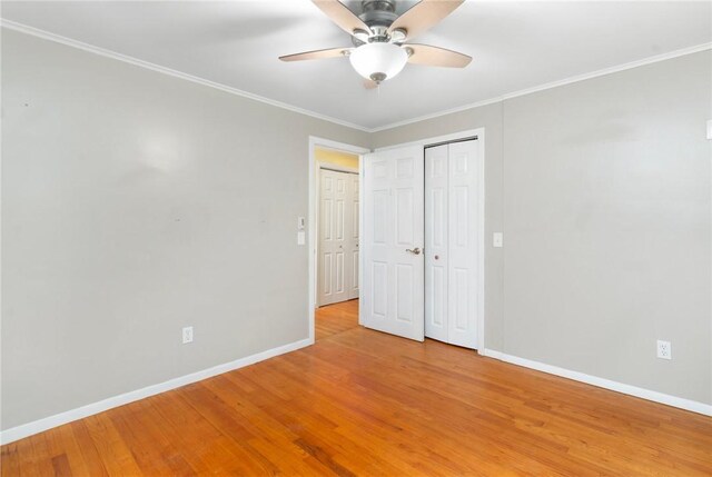 9 Esek Hopkins Rd, Scituate, RI 02857 - unfurnished bedroom featuring light wood-style flooring, crown molding, a closet, and a ceiling fan