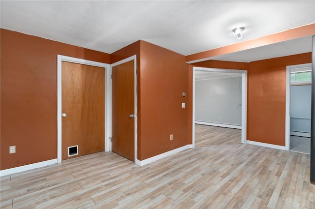 9 Esek Hopkins Rd, Scituate, RI 02857 - unfurnished room with a baseboard heating unit, light wood finished floors, and baseboard heating