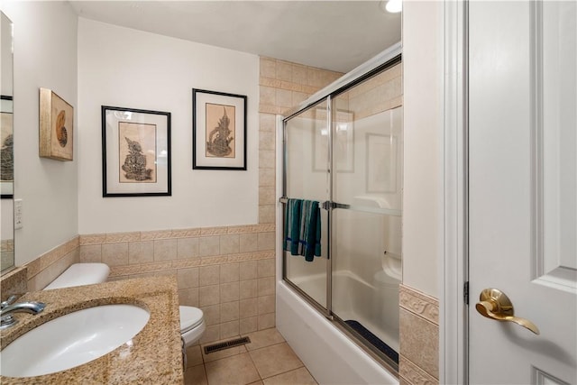 97 Farnum Pike Unit 7, Smithfield, RI 02917 - full bath featuring tile walls, vanity, tile patterned flooring, bath / shower combo with glass door, and wainscoting