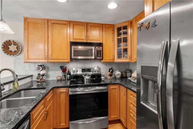 97 Farnum Pike Unit 7, Smithfield, RI 02917 - kitchen with appliances with stainless steel finishes, backsplash, dark stone counters, glass insert cabinets, and recessed lighting