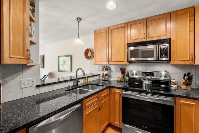 97 Farnum Pike Unit 7, Smithfield, RI 02917 - kitchen with stainless steel appliances, decorative backsplash, brown cabinetry, dark stone countertops, and recessed lighting
