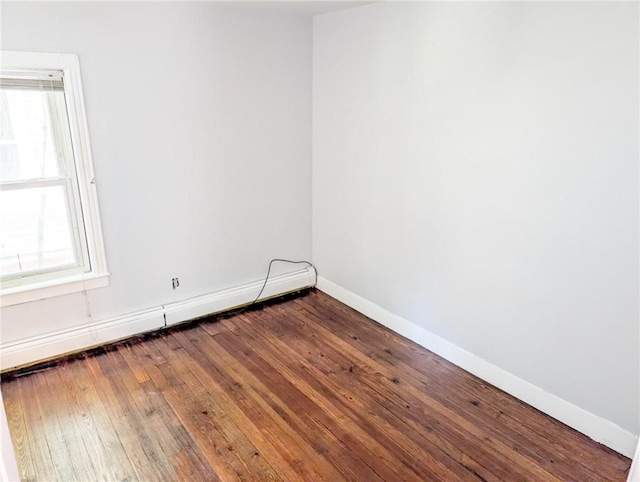 5 Stearns St, Pawtucket, RI 02861 - empty room with a baseboard heating unit and dark wood finished floors