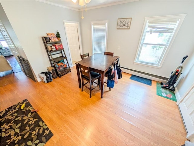 5 Stearns St, Pawtucket, RI 02861 - dining room featuring light wood finished floors, crown molding, plenty of natural light, baseboard heating, and ceiling fan