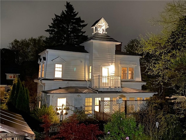 10 Hendricks St, South Kingstown, RI 02879 - back of house at night featuring a balcony