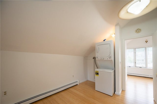 10 Hendricks St, South Kingstown, RI 02879 - laundry area featuring a baseboard heating unit, stacked washer / drying machine, and light wood-style flooring