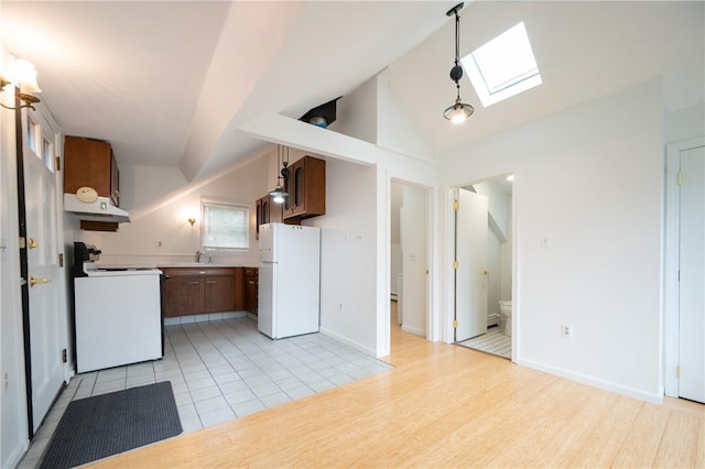 10 Hendricks St, South Kingstown, RI 02879 - kitchen with white appliances, a skylight, custom range hood, vaulted ceiling, and light countertops