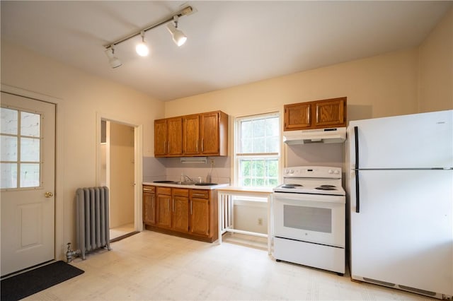 10 Hendricks St, South Kingstown, RI 02879 - kitchen with white appliances, radiator heating unit, under cabinet range hood, and brown cabinets