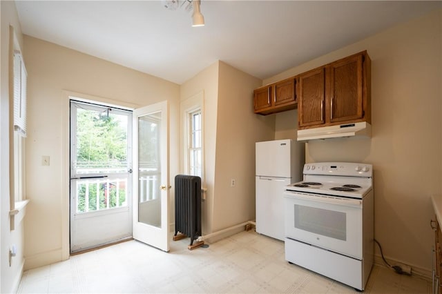 10 Hendricks St, South Kingstown, RI 02879 - kitchen with white appliances, radiator, under cabinet range hood, brown cabinetry, and light flooring