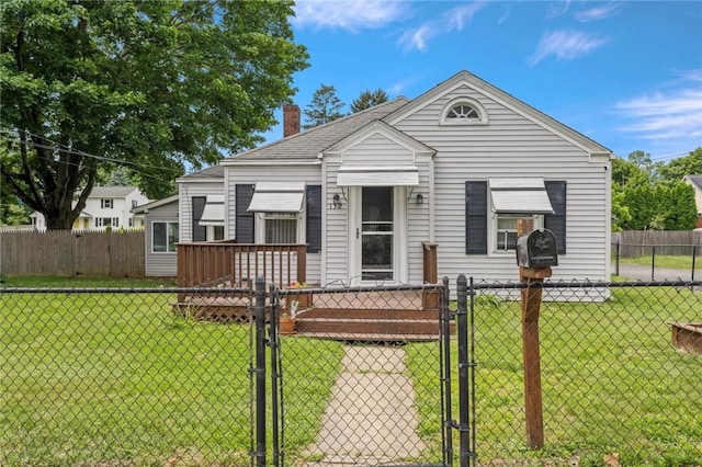 132 W St, West Warwick, RI 02893 - shotgun-style home with a gate, a fenced front yard, and a chimney