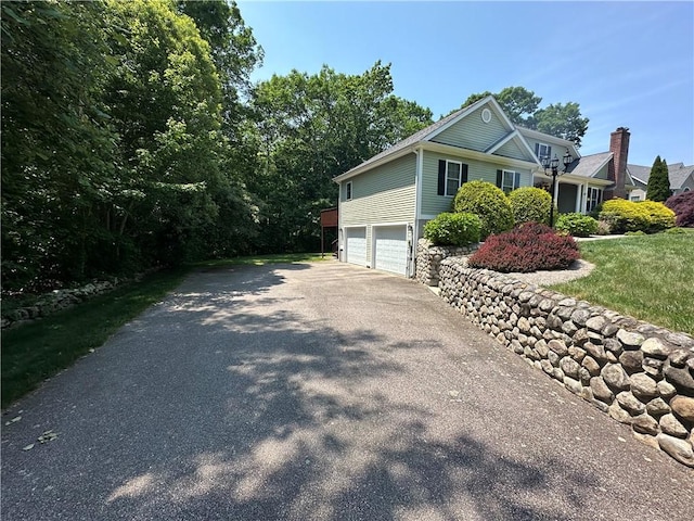 14 Piezzo Dr, Westerly, RI 02891 - view of side of property with an attached garage and driveway