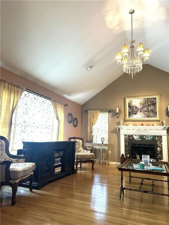 14 Piezzo Dr, Westerly, RI 02891 - sitting room with vaulted ceiling, a chandelier, wood finished floors, and a fireplace