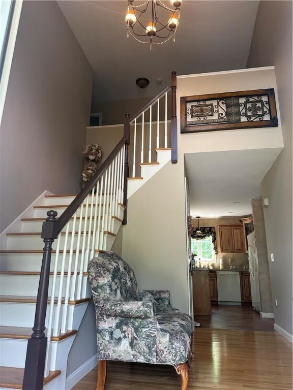 14 Piezzo Dr, Westerly, RI 02891 - staircase with wood finished floors and a chandelier