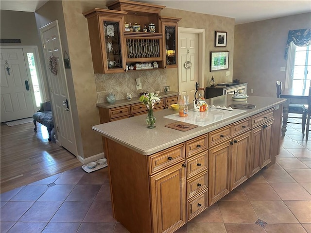 14 Piezzo Dr, Westerly, RI 02891 - kitchen featuring open shelves, tile patterned flooring, light countertops, backsplash, and glass insert cabinets