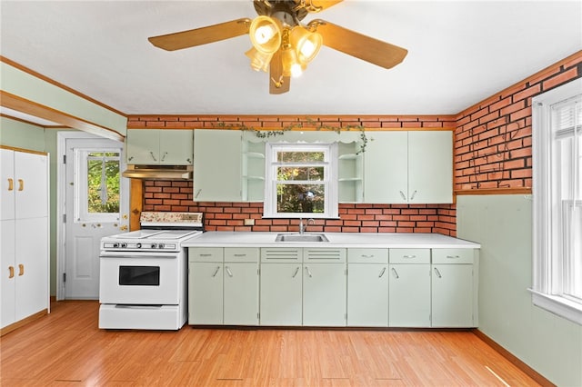 34 Tilden Ave, Warwick, RI 02888 - kitchen featuring white electric stove, under cabinet range hood, open shelves, green cabinets, and plenty of natural light