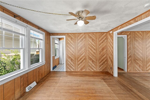 34 Tilden Ave, Warwick, RI 02888 - spare room with wood walls, wood-type flooring, ceiling fan, and a textured ceiling