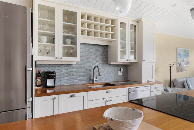 1503 Capella S Unit 1503, Newport, RI 02840 - kitchen with stainless steel appliances, wooden counters, backsplash, and glass insert cabinets