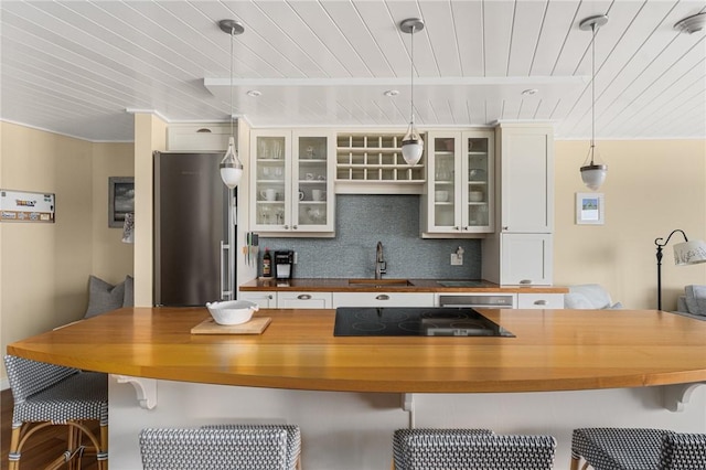 1503 Capella S Unit 1503, Newport, RI 02840 - kitchen featuring butcher block counters, freestanding refrigerator, electric cooktop, wood ceiling, and backsplash