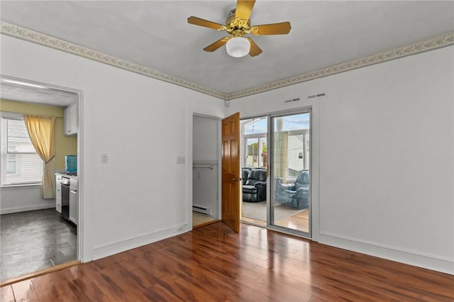 167 Carter Ave, Pawtucket, RI 02861 - unfurnished room featuring wood finished floors, a ceiling fan, and a baseboard heating unit