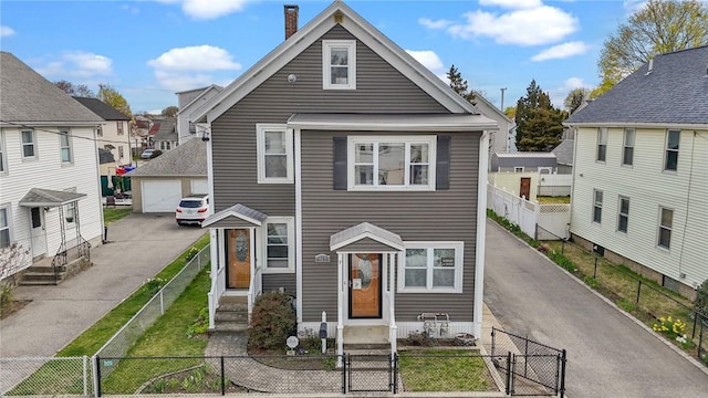 167 Carter Ave, Pawtucket, RI 02861 - view of front of property with a fenced front yard, a garage, a gate, and a chimney