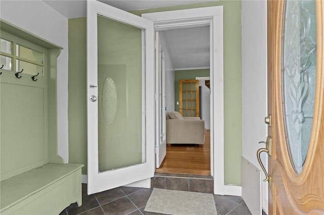 167 Carter Ave, Pawtucket, RI 02861 - mudroom featuring dark tile patterned flooring and ornamental molding