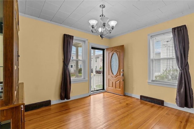 167 Carter Ave, Pawtucket, RI 02861 - entrance foyer with a chandelier, healthy amount of natural light, light wood-style flooring, and crown molding