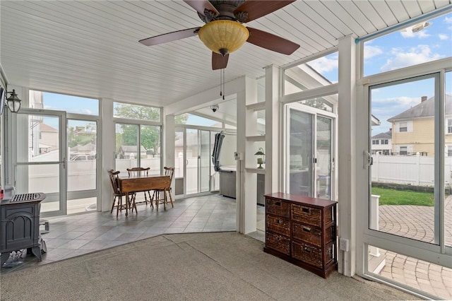 167 Carter Ave, Pawtucket, RI 02861 - sunroom / solarium featuring floor to ceiling windows, plenty of natural light, tile patterned floors, a wood stove, and a ceiling fan
